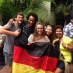 Spanish and German language students cheering together with the German flag during the football world cup.