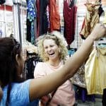Spanish student at clothing store with her private teacher from IIC Spanish School Dominican Republic, laughing and having fun applying her newly acquired language skills in real life situations Spanish SPRiNKLES