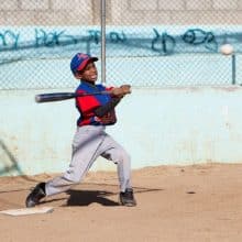 A Dominican boy is playing baseball which is an important part of Dominican every-day culture and talked about the cultzure class at IIC Spanish School in the Dominican Republic.