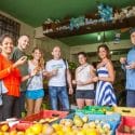 Spanish students who are learning Spanish at IIC, are trying fresh and exotic fruits on an educational tour to the market in Sosua Los Charamicos with their teacher, one of the class activities to encourage students to speak Spanish.