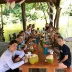 Spanish language students drink Coco Loco, a typical Dominican cocktail (with or without rum) served in a fresh coconut at Rugama Tours, chef Ruddy Martinez.