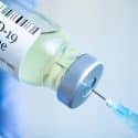Covid-19 vaccination picture shows ampoule and needle.