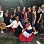 Group of Spanish language students, staff in traditional Dominican costumes and teachers at IIC in Santo Domingo in the Dominican Republic welcome students from around the world to learn Spanish and enjoy learning in the Caribbean.